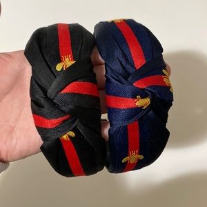 (2) knotted “Gucci” bee headbands in black and navy